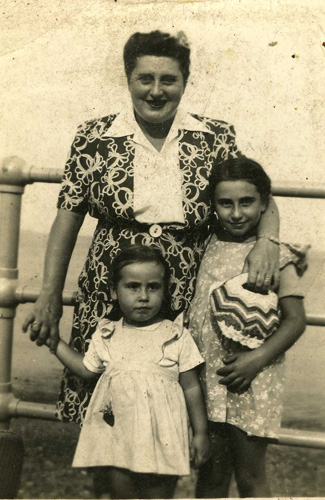 Women standing with two female children on either side